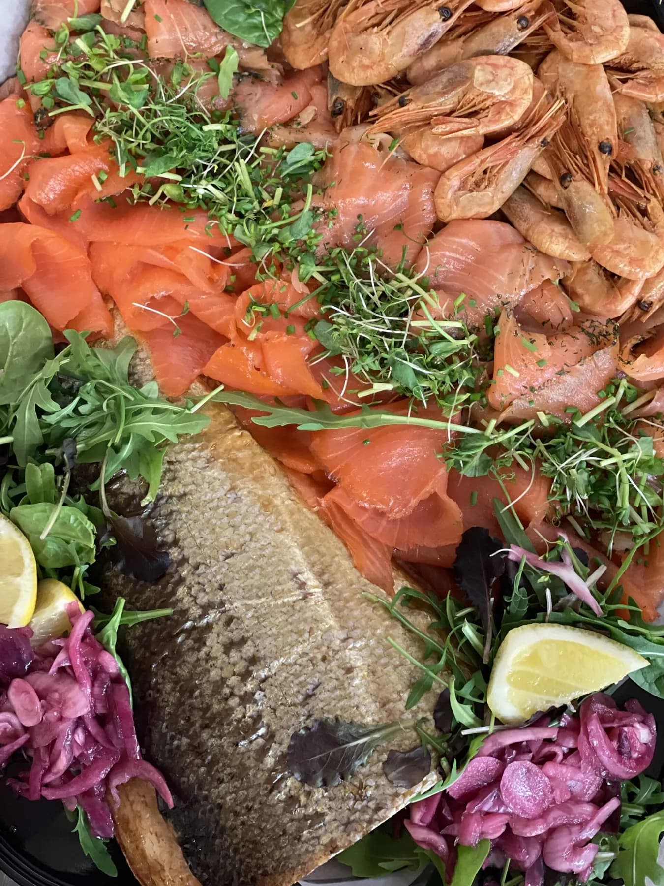 A catering platter of sliced smoked salmon